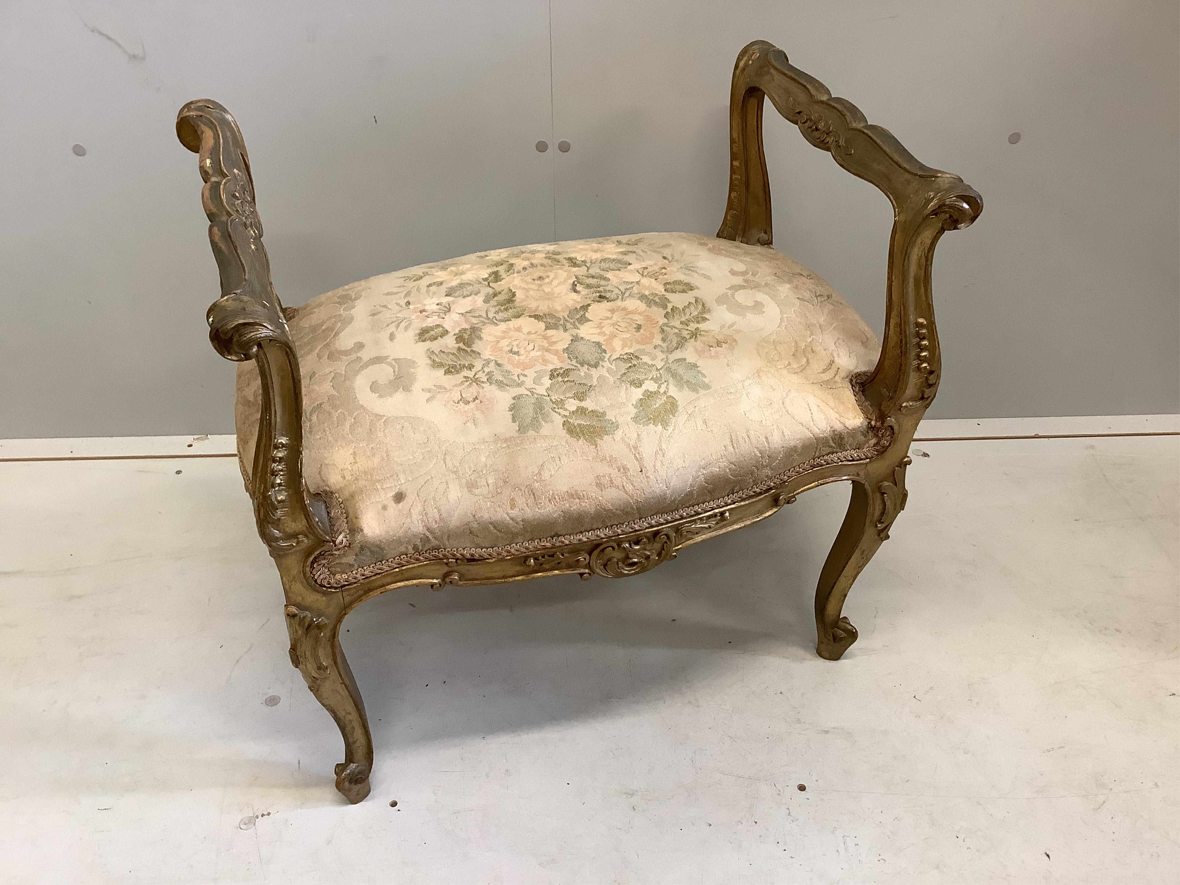 A 19th century French carved giltwood and composition dressing stool, width 62cm, depth 41cm, height 62cm. Condition - fair